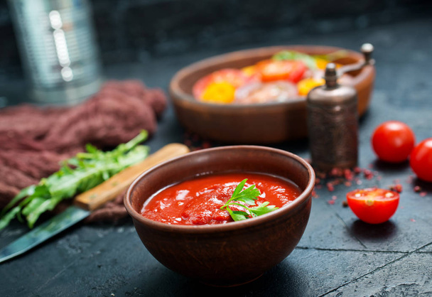 tomato sauce in bowl and fresh tomato on a table - Photo, image