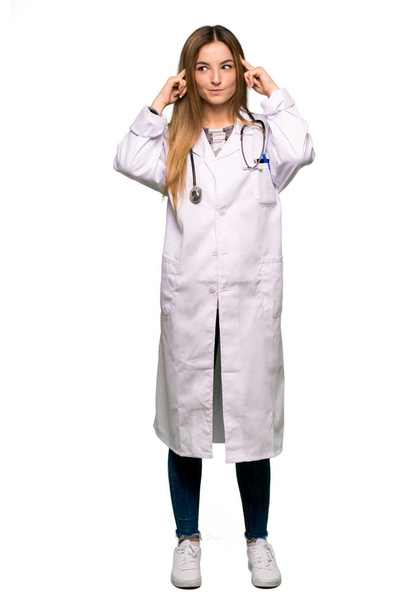 Full body Young doctor woman having doubts and thinking on isolated background - Photo, Image