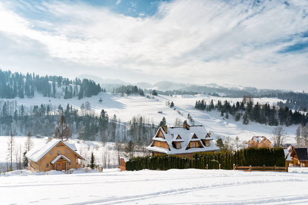 Winter panorama of the mountainous Pieniny village / Poland - slopes and roofs of wooden highland houses covered with snow - Zdjęcie, obraz