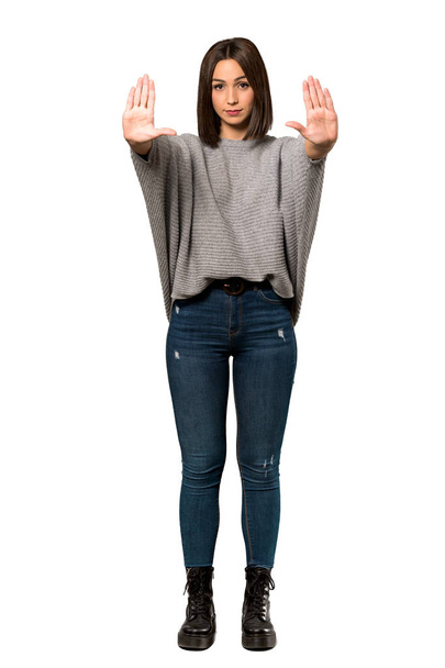 A full-length shot of a Young woman making stop gesture and disappointed over isolated white background - Fotografie, Obrázek