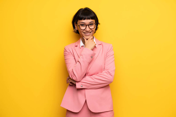 Modern woman with pink business suit with glasses and smiling - Photo, image