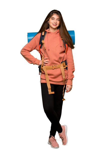 Full-length shot of Hiker girl posing with arms at hip and smiling on isolated white background - Foto, Imagem