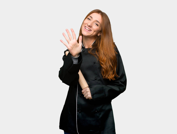 Young redhead chef woman counting five with fingers on isolated grey background - Photo, Image