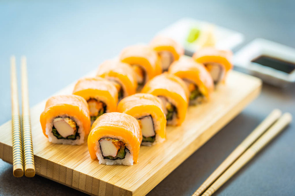 Salmon fish meat sushi roll maki on wood plate with wasabi and soy sauce - Japanese food style - Φωτογραφία, εικόνα