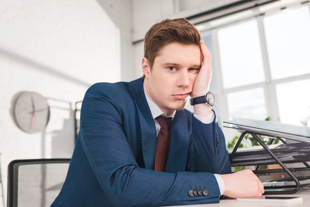 bored businessman sitting and looking at camera in office  - Photo, Image