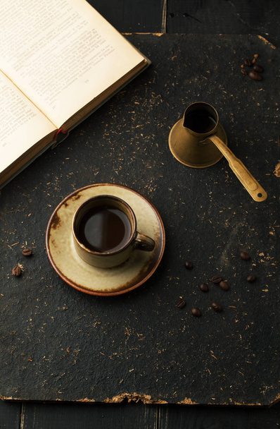 Cup of coffee with book on wood table. Coffee break. - Foto, imagen