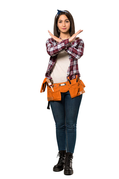 A full-length shot of a Young worker woman making NO gesture over isolated white background - Foto, Imagem