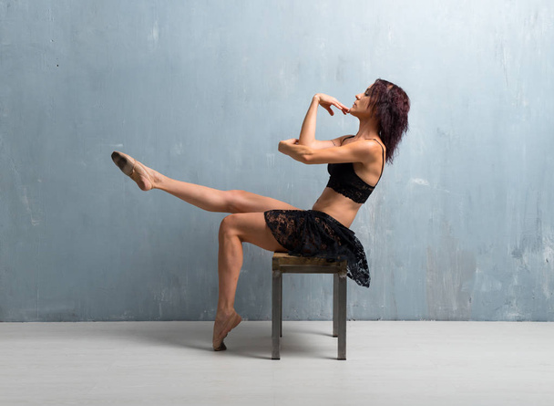 Ballerina dancing on grunge wall background - Фото, зображення