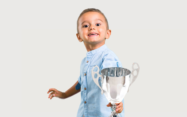 Little kid holding a trophy - Fotó, kép