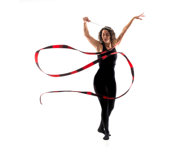 Woman doing rhythmic gymnastics with ribbon on isolated white background - Foto, afbeelding