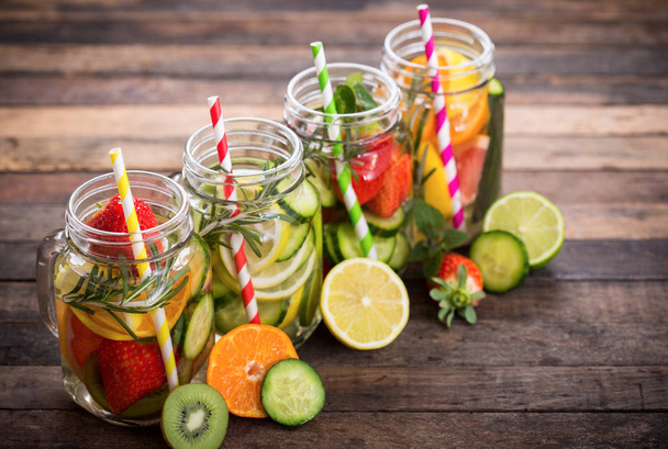healthy drinks with fresh vegetables and fruits on wooden tabletop - Фото, зображення