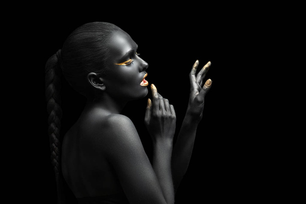black background and black woman with chic gold makeup - Foto, imagen