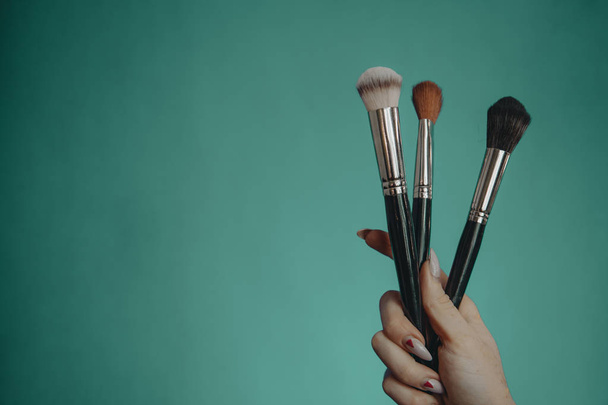 Make up brushes on turquoise background - Photo, Image