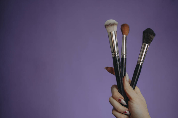 Make up brushes on purple background - Photo, Image