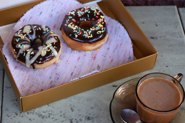 box with doughnuts and cup of coffee - 写真・画像