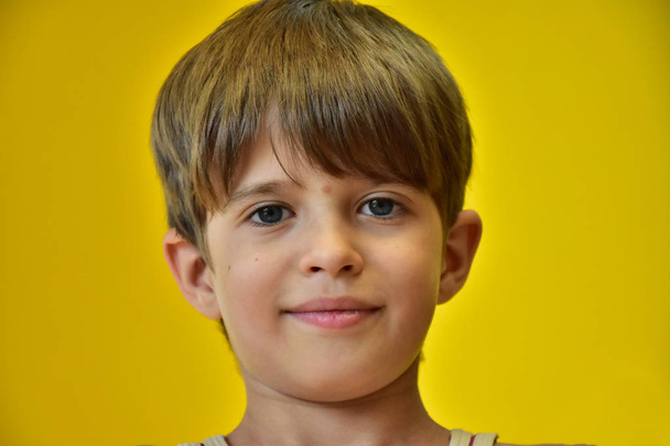 retrato de uma criança contra fundo amarelo
  - Foto, Imagem