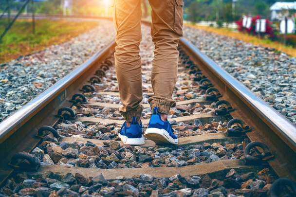 Feet of male walking on railroad. Travel concept. - Foto, Imagen