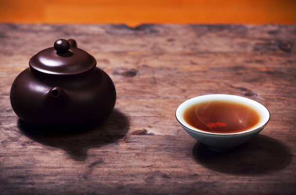 Teapot black hot tea cup wooden desk  - 写真・画像