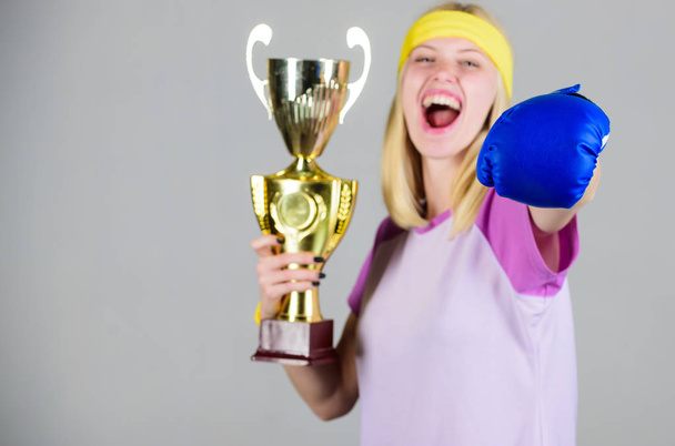 Sport achievement. Celebrate victory. Boxing champion. Athletic girl boxing glove and golden goblet. Woman wear sport outfit. Girl cheerful boxer winner. Boxing is my hobby. Success in boxing - Fotoğraf, Görsel