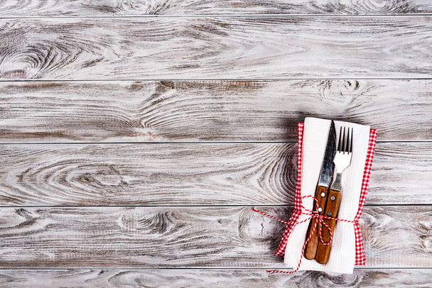Empty wooden table background and fork and knife on napkin. Dinner, lunch or breackfast concept. - Foto, immagini