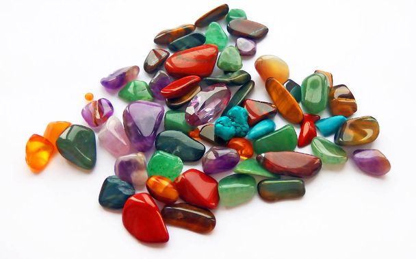 Assorted natural bright coloured semi precious gemstones and gems on white background - Photo, Image