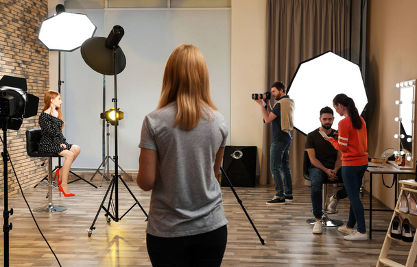 Photo studio with professional equipment and team of workers - Foto, immagini
