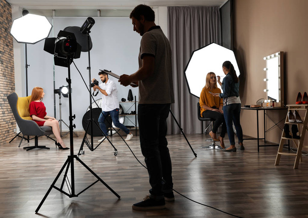 Photo studio with professional equipment and team of workers - Zdjęcie, obraz
