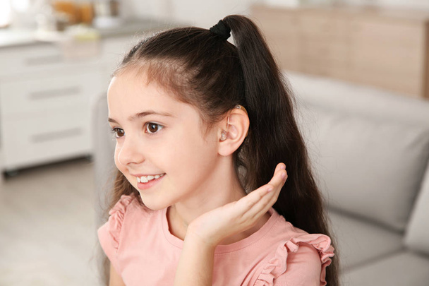 Little girl with hearing aid at home - Φωτογραφία, εικόνα