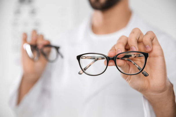 Male ophthalmologist with eyeglasses in clinic, closeup. Space for text - Photo, Image