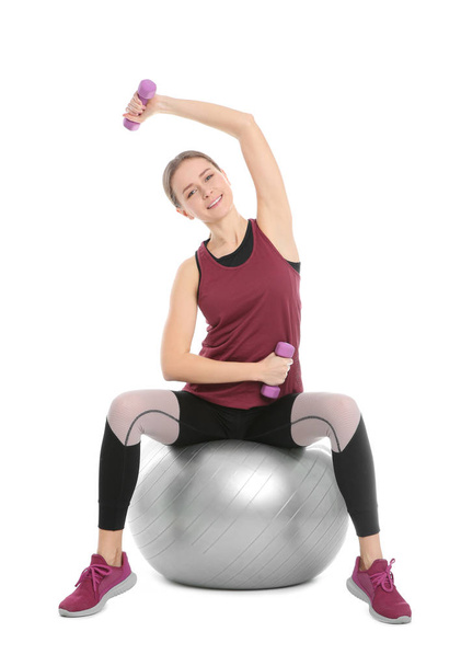 Young woman doing sports exercises isolated on white. Home fitness - Foto, afbeelding