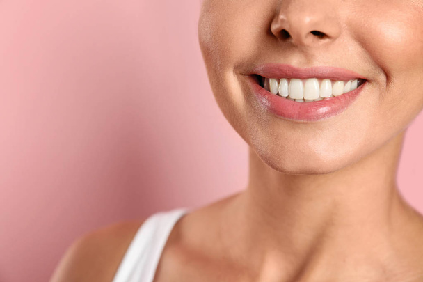 Young woman with healthy teeth on color background, closeup. Space for text - Фото, изображение