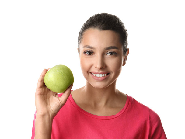 Young woman with healthy teeth and apple on white background - Foto, afbeelding