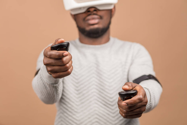 Black man wearing 3d vr glasses, playing videogame, holding joystick in hands - Fotografie, Obrázek