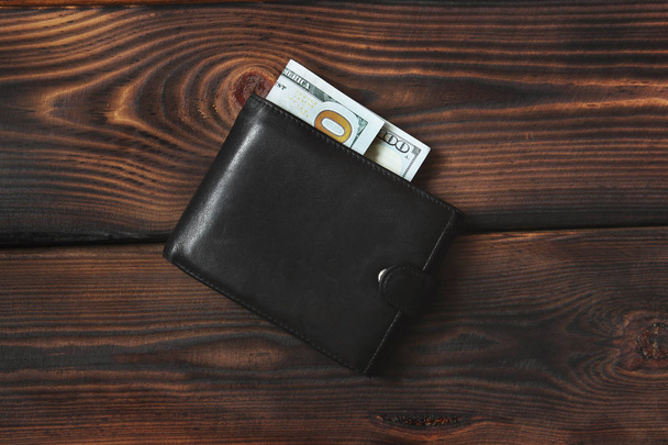 Dollars on a wooden background. Money in your wallet - Φωτογραφία, εικόνα