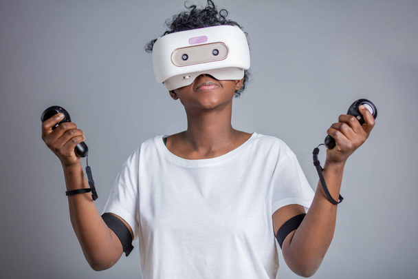 Young african student girl playing with virtual reality glasses. - Photo, image