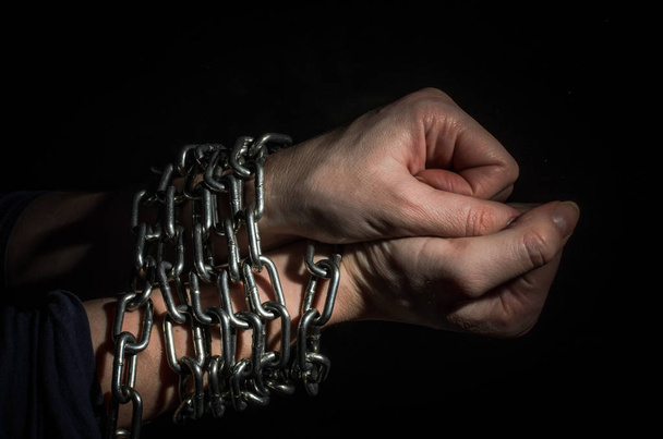 Hands chained in chains isolated on black background - Fotoğraf, Görsel