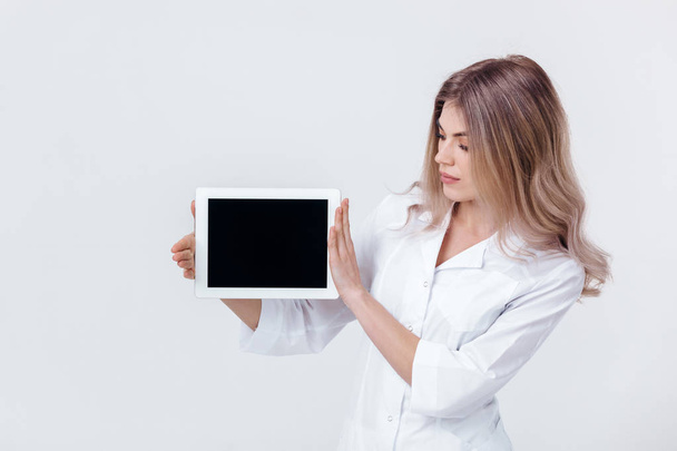 P young doctor showing the screen of digital tablet - Fotó, kép