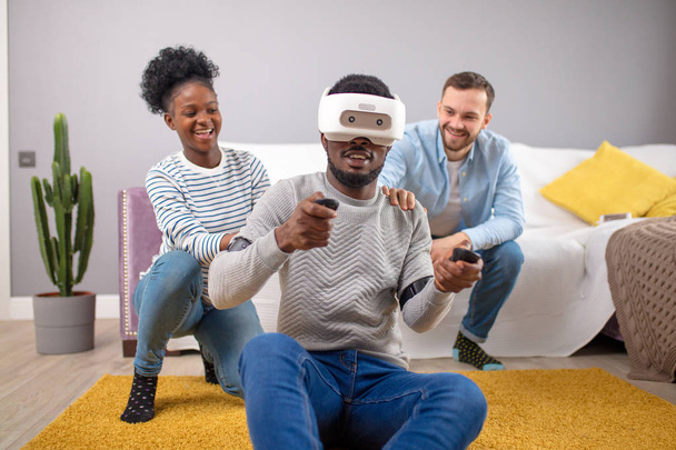 Multiracial group of friends having fun trying on 3D virtual reality goggles. - Φωτογραφία, εικόνα