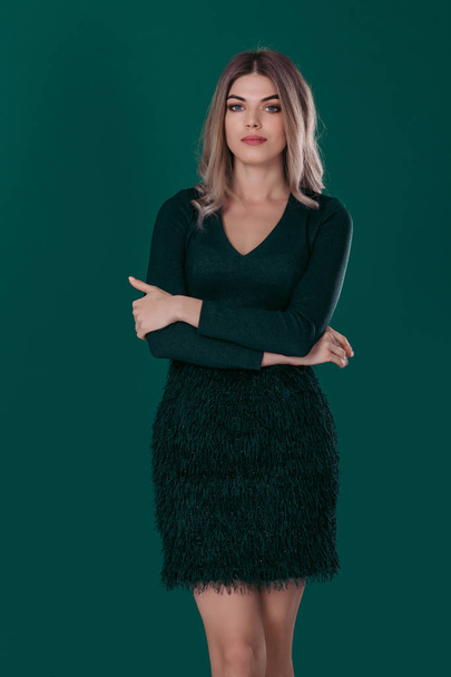 blonde woman posing in green dress on green background - Fotoğraf, Görsel