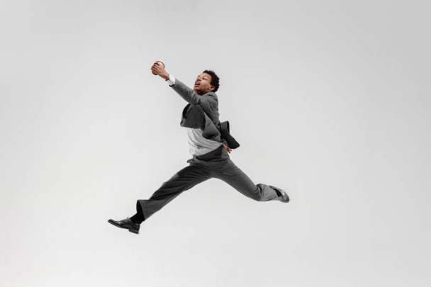 Happy businessman dancing isolated on gray studio background - Zdjęcie, obraz