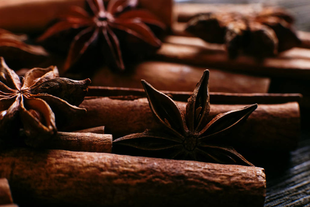 Spices sticks cinnamon and star anise on old table. Rustic dark background, aroma close-up, macro. - Photo, Image