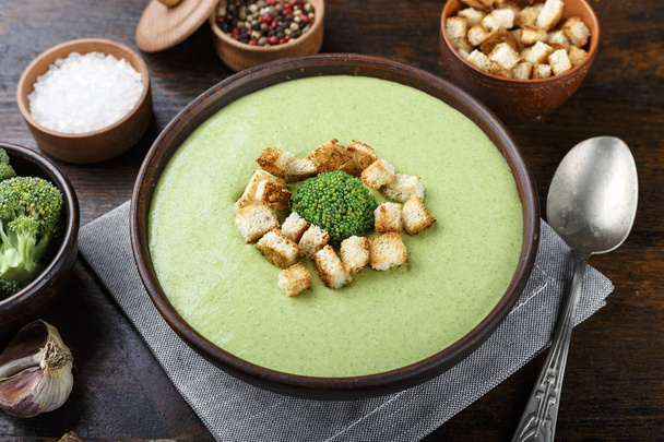lunch broccoli soup on a wooden table. nearby are crouton - 写真・画像