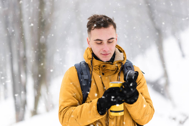 Tourist Boy Warming Hands on a Thermos - Valokuva, kuva