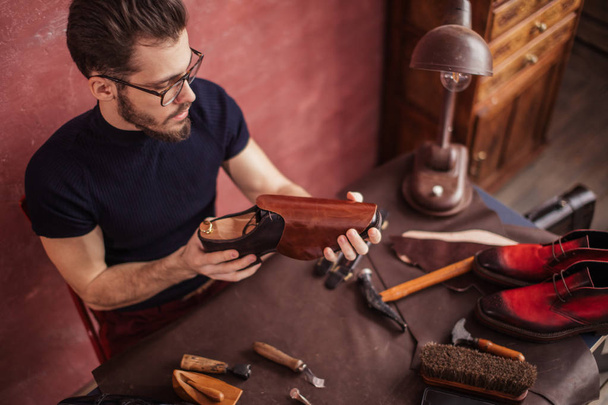 man making shoes for customers. individual order. close up photo - Valokuva, kuva