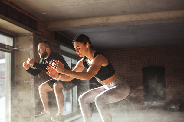 Hombre y mujer saltando tohether en cajas en el gimnasio, entrenamiento funcrional para las personas
 - Foto, imagen