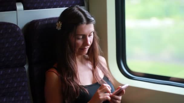 Young woman traveling by train - Filmati, video