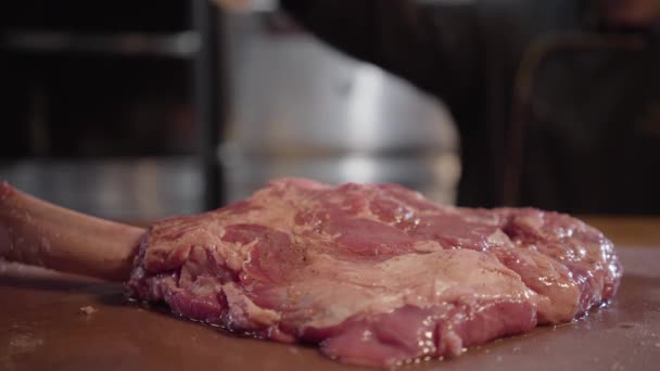 Chef oiling the raw fresh piece of meat ribs marinated and ready to be fried in grill after marinade. Close up - 映像、動画