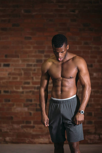 Handsome African bodybuilder man with naked muscular torso. Sport Concept. - Zdjęcie, obraz