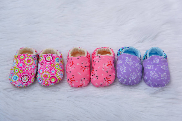 Fabric Slippers for newborns. Shoes made of material. Booties for newborns. Booties made of multi-colored material. Slippers for small children. Three pairs of baby Slippers. - Photo, Image