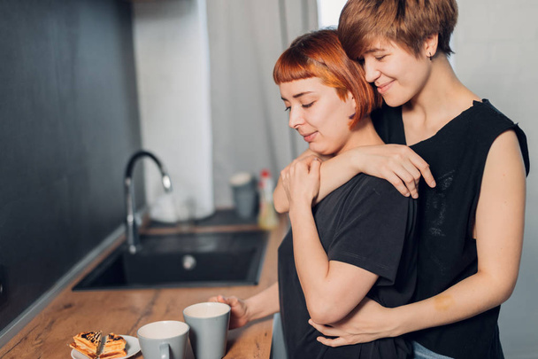 two female loves standing in the kitchen - Photo, Image